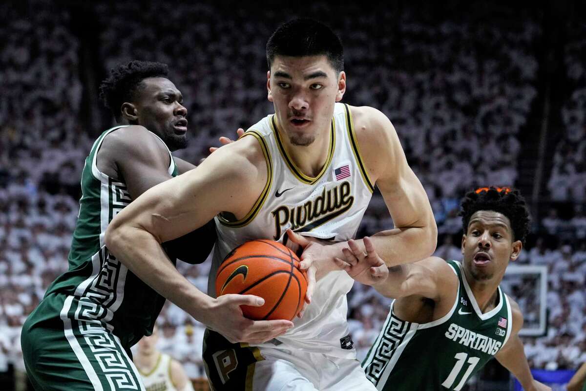 Purdue center Zach Edey (15) moves to the basket between Michigan State center Mady Sissoko (22) and guard A.J. Hoggard (11)during the second half of an NCAA college basketball game in West Lafayette, Ind., Sunday, Jan. 29, 2023. Purdue defeated Michigan State 77-61.