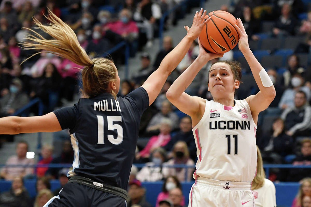 UConn's Lou Lopez-Senechal (11) shoots over Villanova's Brooke Mullin (15) in the first half of an NCAA college basketball game, Sunday, Jan. 29, 2023, in Hartford, Conn. (AP Photo/Jessica Hill)