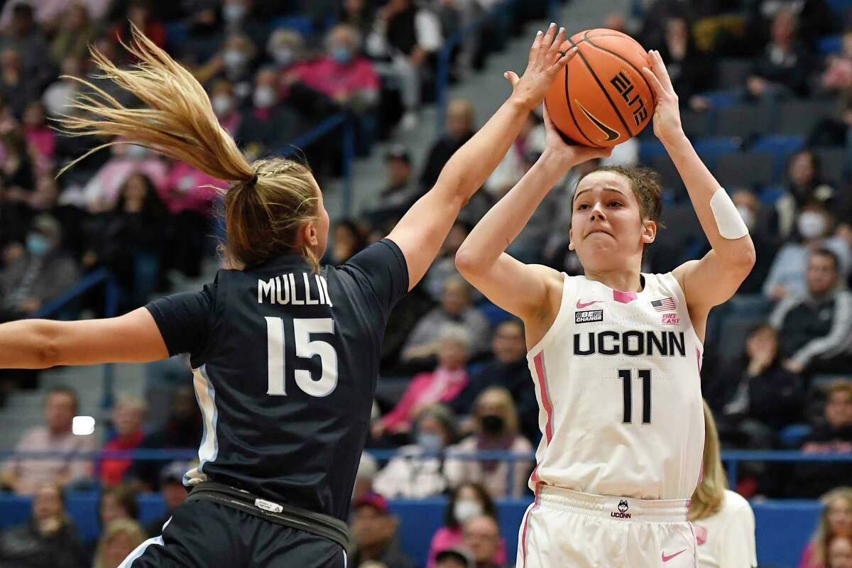 UConn's Lou Lopez-Senechal (11) shoots over Villanova's Brooke Mullin (15) in the first half of an NCAA college basketball game, Sunday, Jan. 29, 2023, in Hartford, Conn.