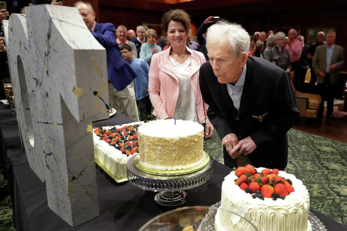 Jackie Burke, right, blows out a birthday candle as his wife Robin Burke, left, looks on during the 100th birthday party for Jackie Burke at his Champions Golf Club Sunday, Jan. 29, 2023 in Houston, TX.