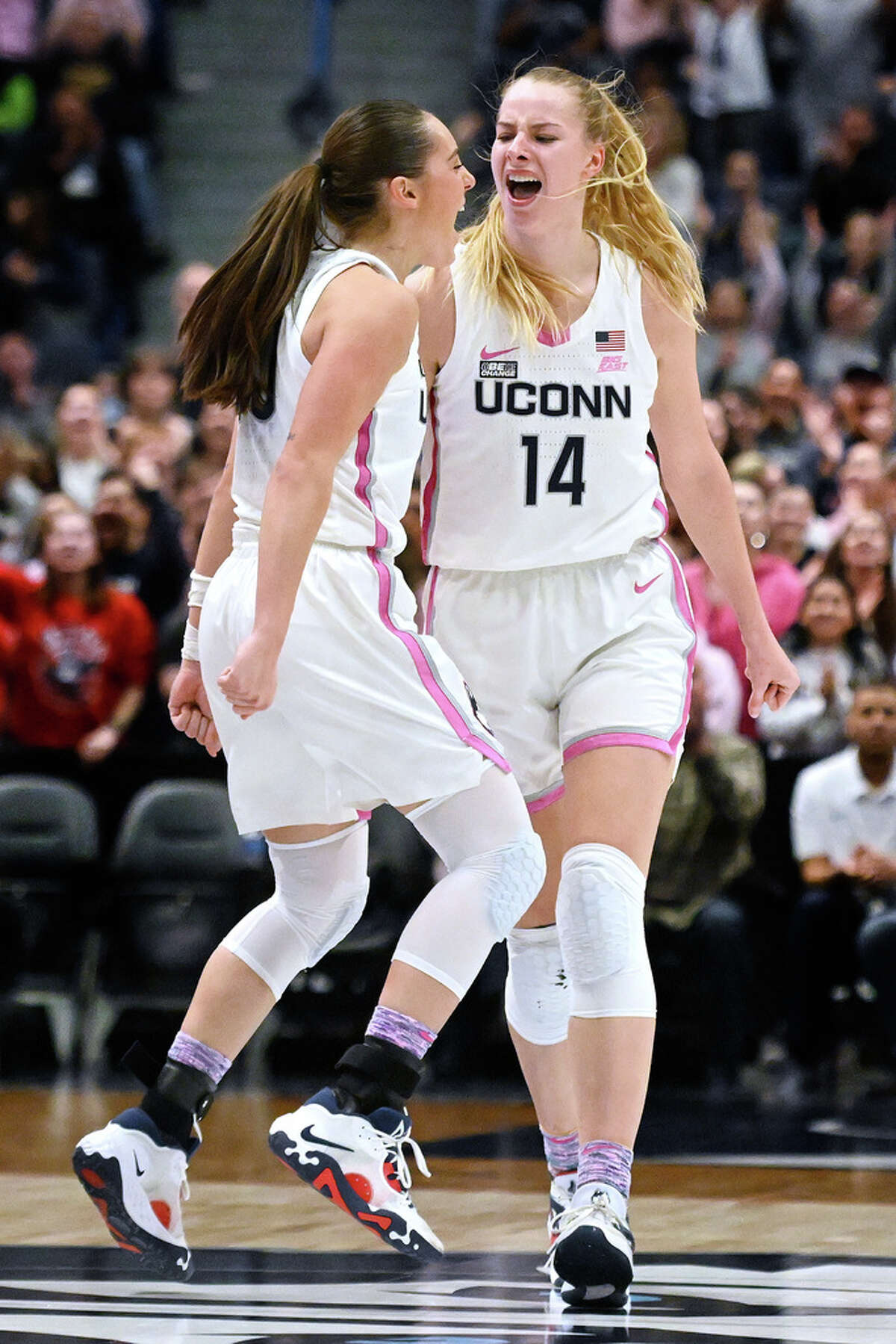 UConn's Dorka Juhasz (14) celebrates after her 3-point basket with teammate Nika Muhl in the second half of an NCAA college basketball game against Villanova, Sunday, Jan. 29, 2023, in Hartford, Conn. (AP Photo/Jessica Hill)