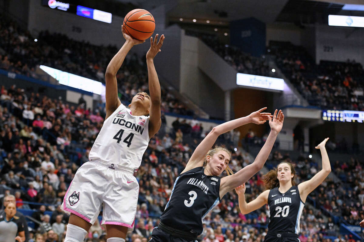 UConn's Aubrey Griffin (44) goes up for a basket while fouled by Villanova's Lucy Olsen (3) in the second half of an NCAA college basketball game, Sunday, Jan. 29, 2023, in Hartford, Conn. (AP Photo/Jessica Hill)
