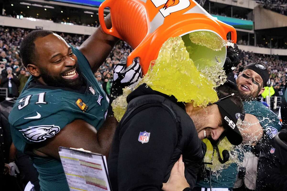Philadelphia Eagles head coach Nick Sirianni, center, is doused by defensive tackle Fletcher Cox (91) and teammates during the second half of the NFC Championship NFL football game between the Philadelphia Eagles and the San Francisco 49ers on Sunday, Jan. 29, 2023, in Philadelphia.