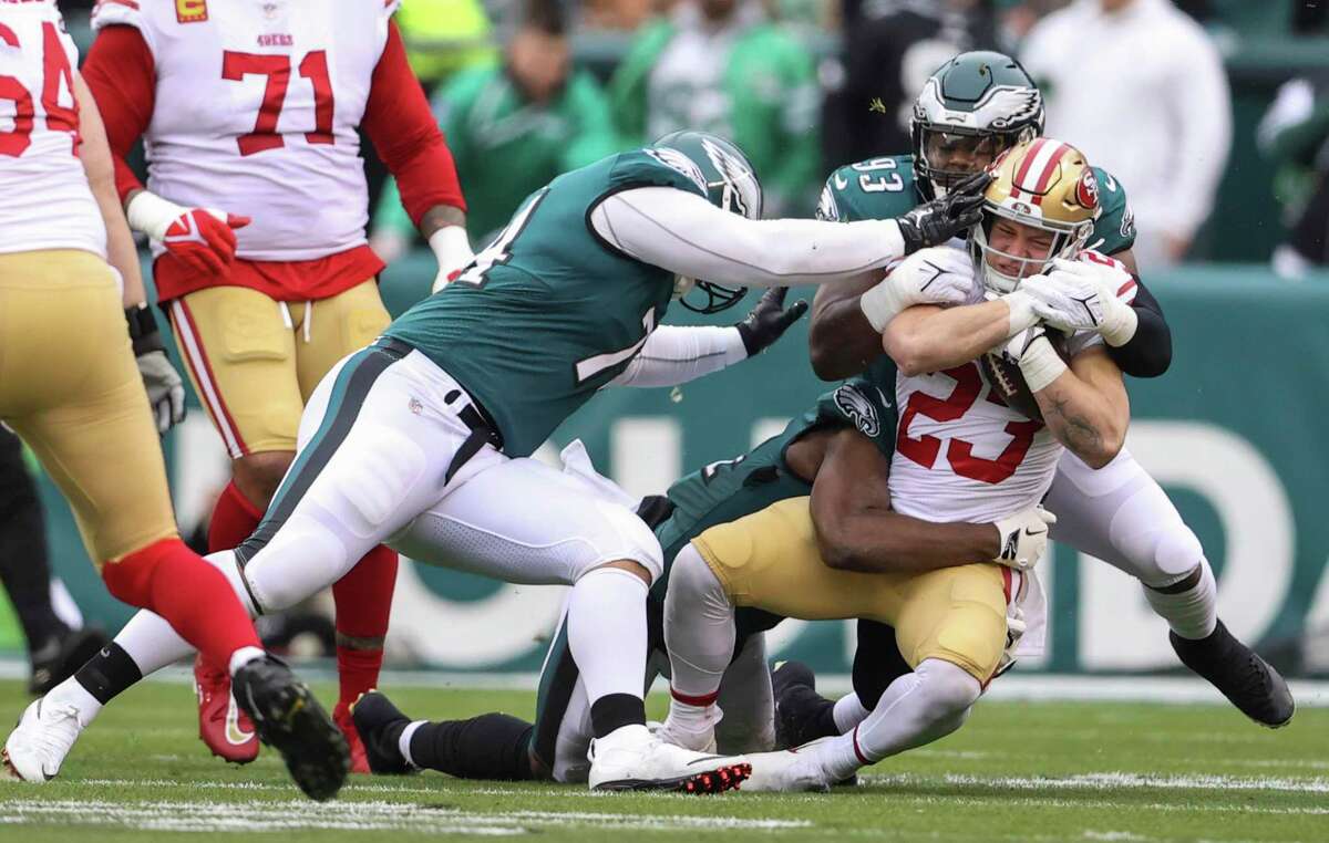 San Francisco 49ers' running back Christian McCaffrey, 23, is tackled by Philadelphia Eagles' tackle Milton Williams, 93, in the first quarter during the NFC Championship Game at Lincoln Financial Field in Philadelphia, Pa., on Sunday, Jan. 29, 2023.