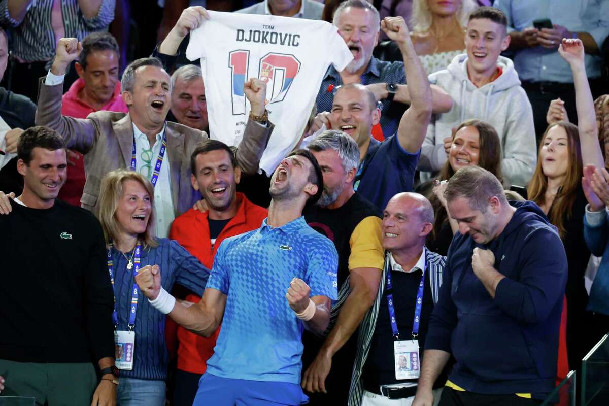 Novak Djokovic (center) rejoices with his team after beating Stefanos Tsitsipas in the men’s singles final at the Australian Open.