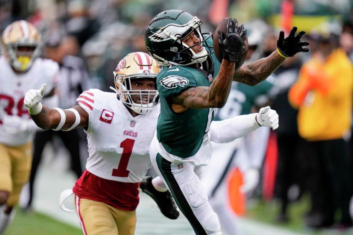 Eagles wide receiver DeVonta Smith catches a pass in front of 49ers cornerback Jimmie Ward.