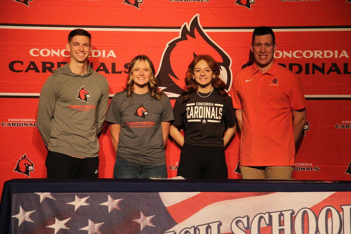 USA's Olivia Tomlinson and Gabi Reinbold both celebrate their signings with Concordia coaches.