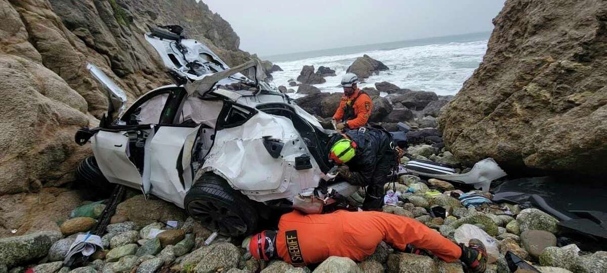 In this photo provided by the San Mateo County Sheriff's Office, emergency personnel respond to a vehicle over the side of Highway 1 on Jan. 1, 2023, in San Mateo County, Calif. The driver of the car that plunged 250 feet off a cliff in Northern California, injuring his two young children and his wife, has been released from the hospital and jailed on suspicion of attempted murder and child abuse. The San Mateo County District Attorney's Office announced Friday, Jan. 27, 2023, that Dharmesh Patel is being held without bail.