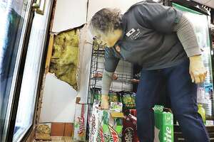 Icy lot sends car into store's wall