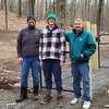 Joined by his father, Jacob Cedusky, left, and Paul Hirsch of Hirsch Construction Services, right, Ian Cedusky stands in front of the dog park he built for his Eagle Scout project in Topstone Park in Redding, Conn.