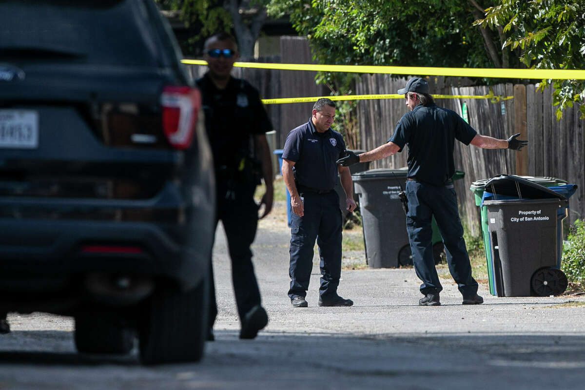 Members of the SAPD Crime Scene Unit talk as they work on the scene of an officer-involved shooting at a home in the 1100 block of Bammel Lane on Oct. 6, 2022.