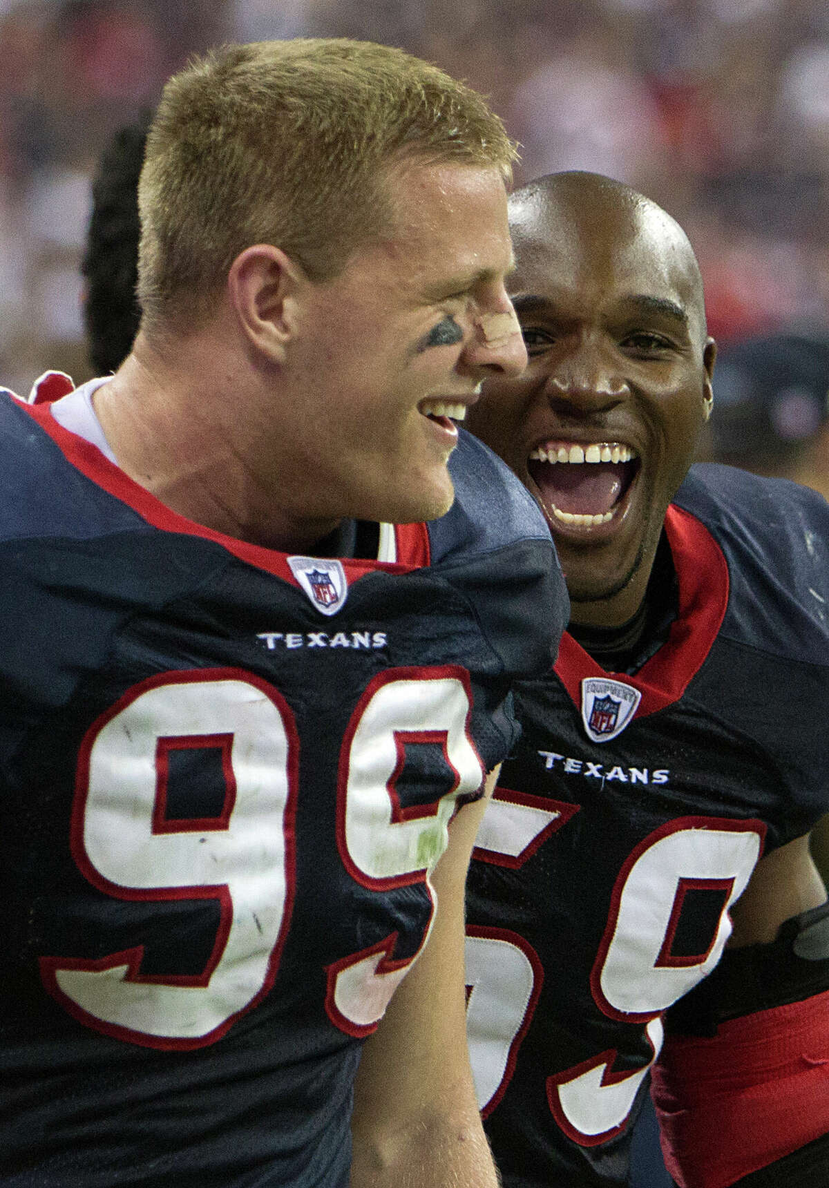 Houston Texans defensive end J.J. Watt (99) celebrates with inside linebacker DeMeco Ryans (59) during the fourth quarter of an AFC wildcard playoff football game against the Cincinnati Bengals at Reliant Stadium on Saturday, Jan. 7, 2012, in Houston. The Texans won 31-10.