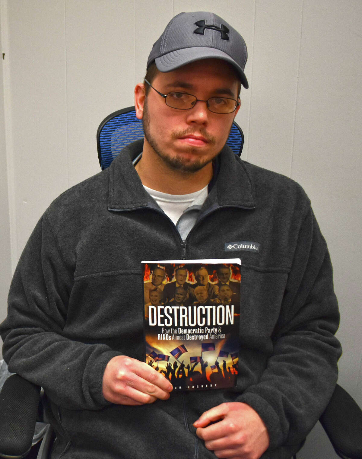 Zach Hackert, a 2021 graduate of Illinois College and a Navy veteran, has written his first book, "Destruction: How the Democratic Party & RINOs Almost Destroyed America." It was published by Defiance Press & Publishing and released in December.