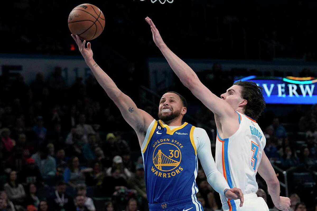 Warriors guard Stephen Curry (30) shoots in front of Oklahoma City Thunder guard Josh Giddey (3) in the first half of an NBA basketball game Monday, Jan. 30, 2023, in Oklahoma City. (AP Photo/Sue Ogrocki)
