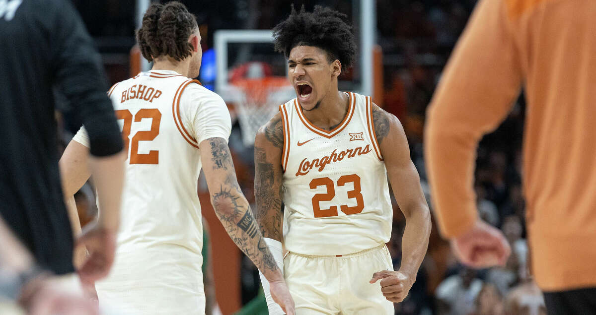 Texas forward Dillon Mitchell (23) celebrates after scoring against Baylor with forward Christian Bishop (32) of an NCAA college basketball game Monday, Jan. 30, 2023, in Austin, Texas. (AP Photo/Stephen Spillman)