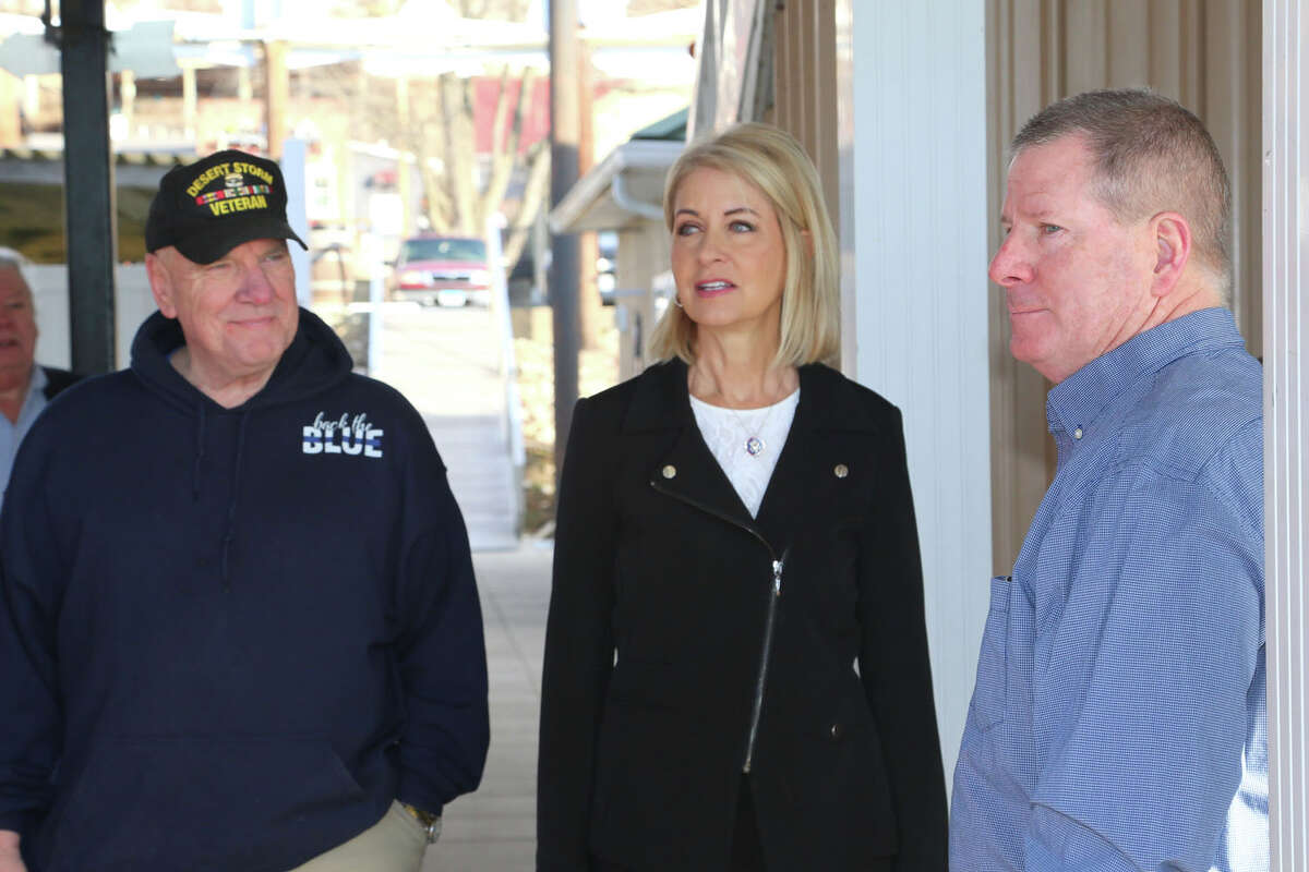 Congresswoman Mary Miller, center, tours Grafton Harbor as she stands by Grafton Mayor Mike Morrow, left, and co-owner Joe DeSherlia, right, who owns the marina business with his wife, Jan DeSherlia, not pictured.