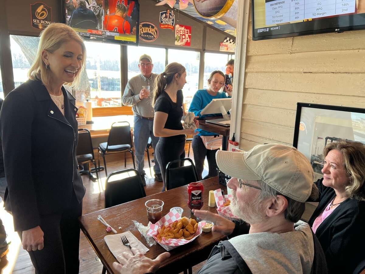 Congresswoman Mary Miller (left) talks to people at Grafton Pub, where she ate lunch Sunday when she and her husband, state Rep. Chris Miller, visited and toured the city. 