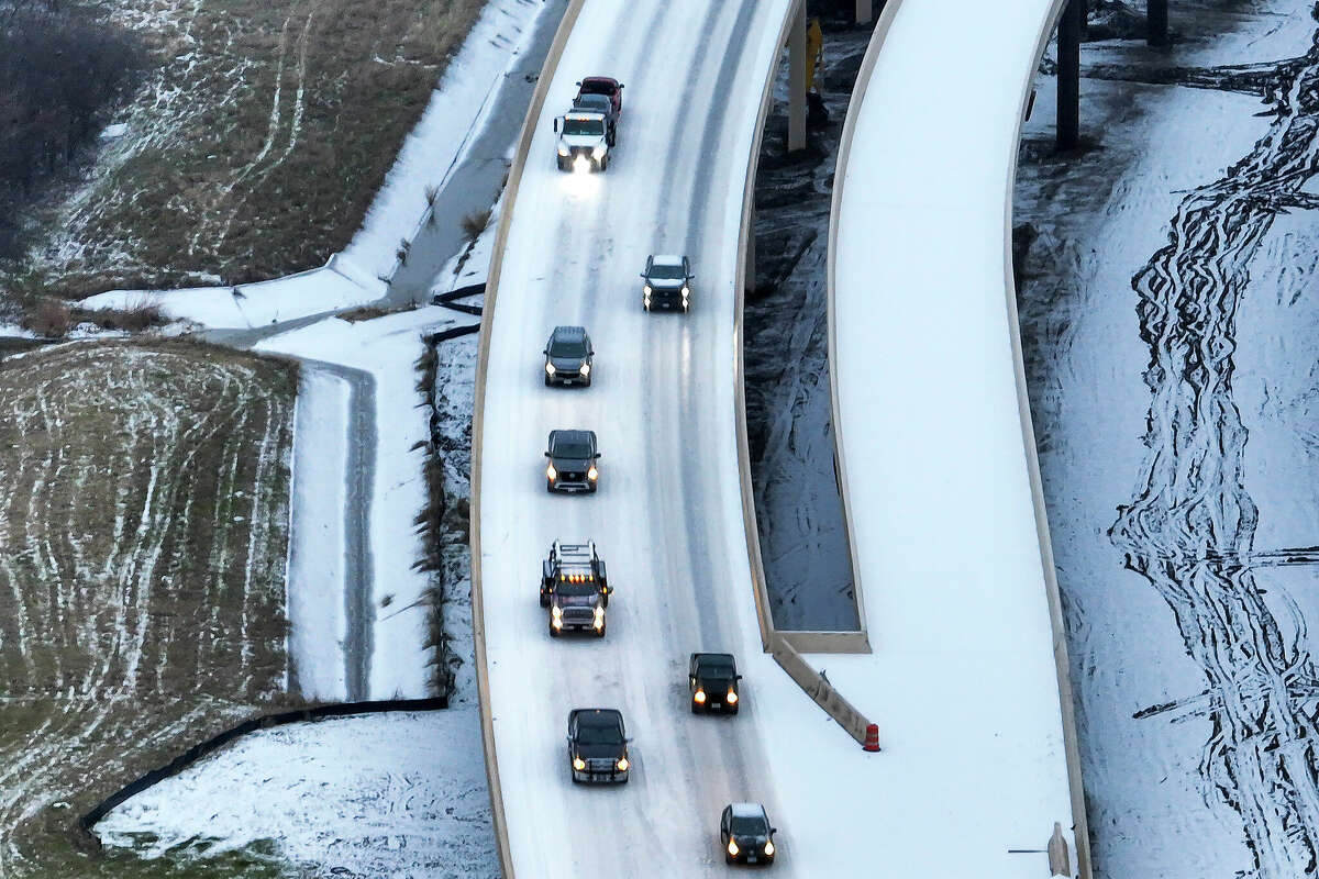 An icy mix covers Highway 114 on Monday, Jan. 30, 2023, in Roanoke, Texas. Dallas and other parts of North Texas are under a winter storm warning through Wednesday.