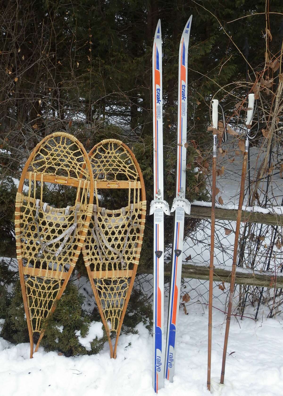 Tom Lounsbury has used the very dependable and durable rawhide and ash snowshoes (left) for many winters. The cross-country skis and poles (right) are a new outdoor adventure for him, especially if he can figure out how to come to a sudden stop without falling!