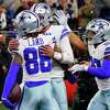 CeeDee Lamb of the Dallas Cowboys is congratulated by Dak Prescott and Tony Pollard during the fourth quarter against the Philadelphia Eagles on December 24, 2022 in Arlington.