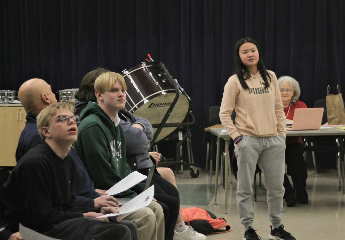 Freshman Clear Wang, a member of the Manistee Area Public Schools student advisory committee, presents the Mariners as a potential mascot on Jan. 30 during a school board meeting.