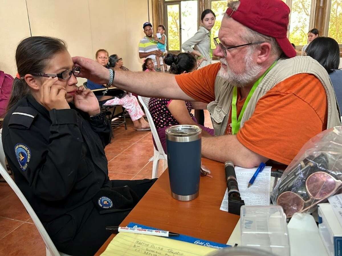 VOSH-CT, a team of optometrists, students and volunteers, took their annual trip to San Juan del Sur in Nicaragua in early January. The mission trip provides eye care and glasses to thousands of residents during the weeklong clinics. Dr. Matthew Blondin, founder of VOSH-CT, helps a child with her new glasses at the clinic. 