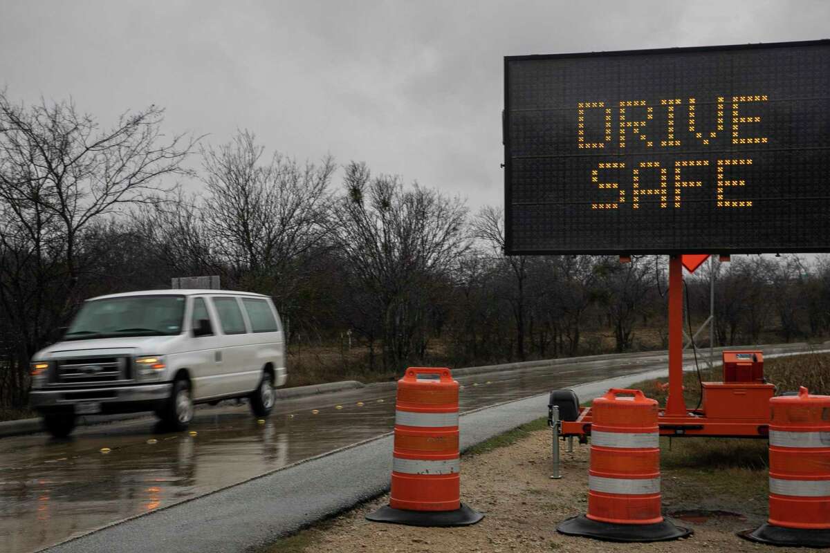 A car zooms past a sign warning drivers to “drive safe” as along Lookout Road in Live Oak, Texas, on Jan. 31, 2023. San Antonio is now under a winter weather warning through Thursday morning as a “significant ice storm” moves through the region.