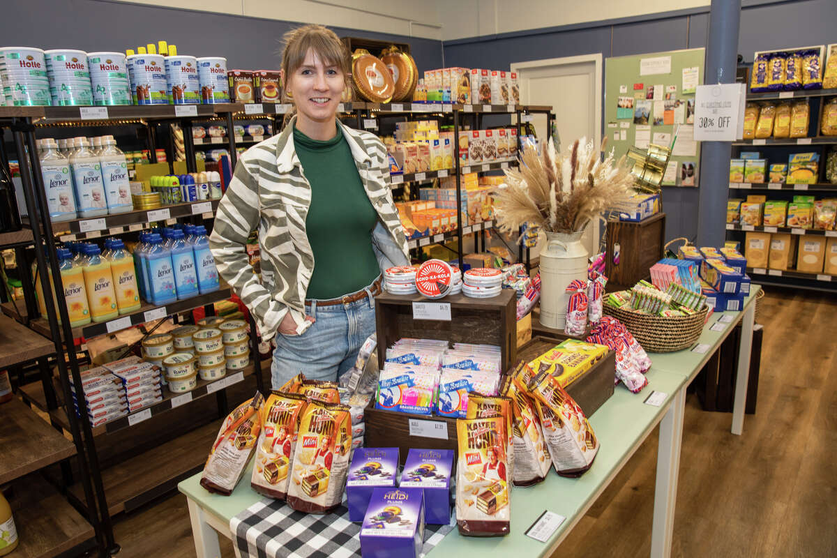 Lehr's German Specialties new owner Hannah Seyfert poses with some of the german food items available at her store in the Noe Valley of San Francisco, Calif. on Jan. 29, 2023.