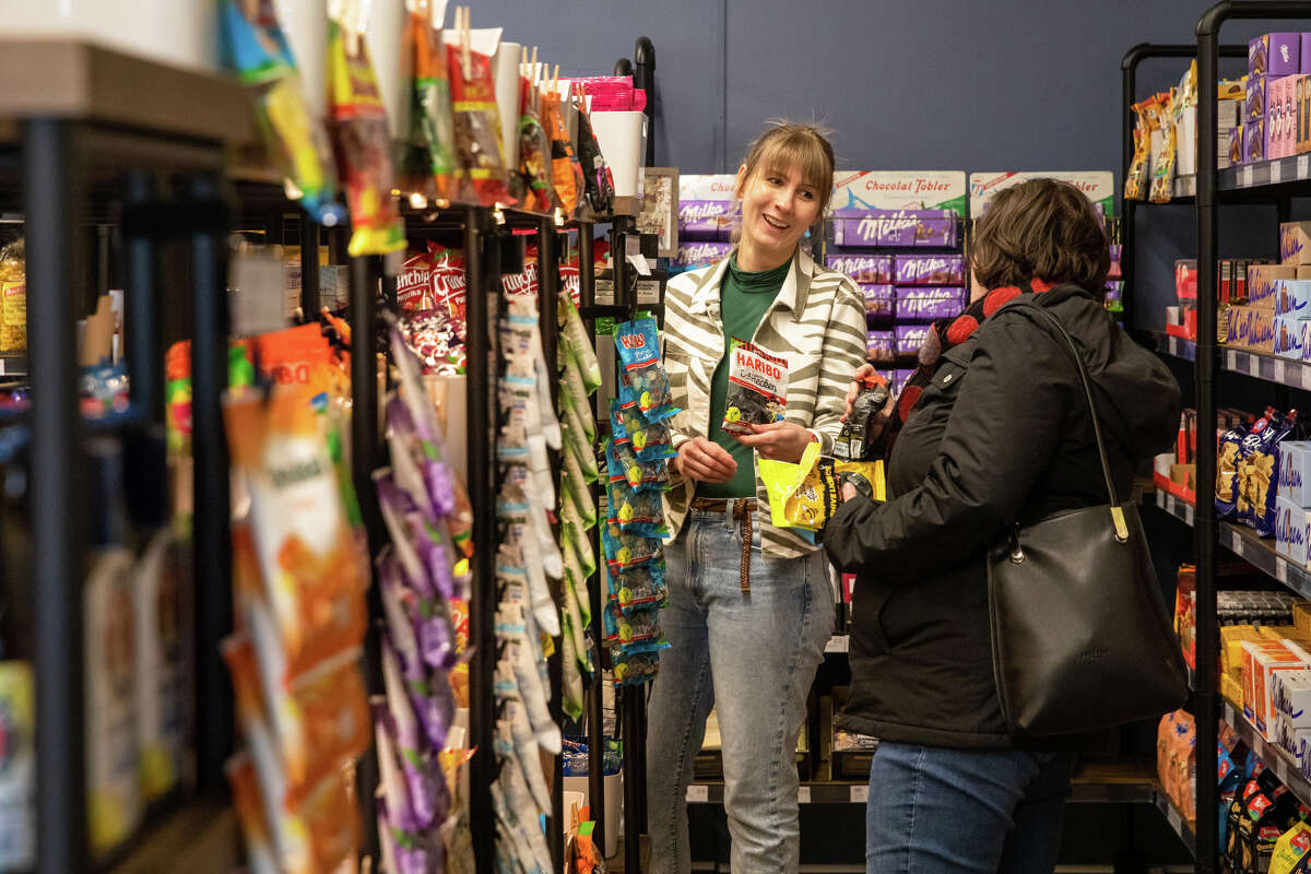 Lehr's German Specialties new owner Hannah Seyfert helps a customer search for candies at Lehr's German Specialties in the Noe Valley of San Francisco, Calif. on Jan. 29, 2023.