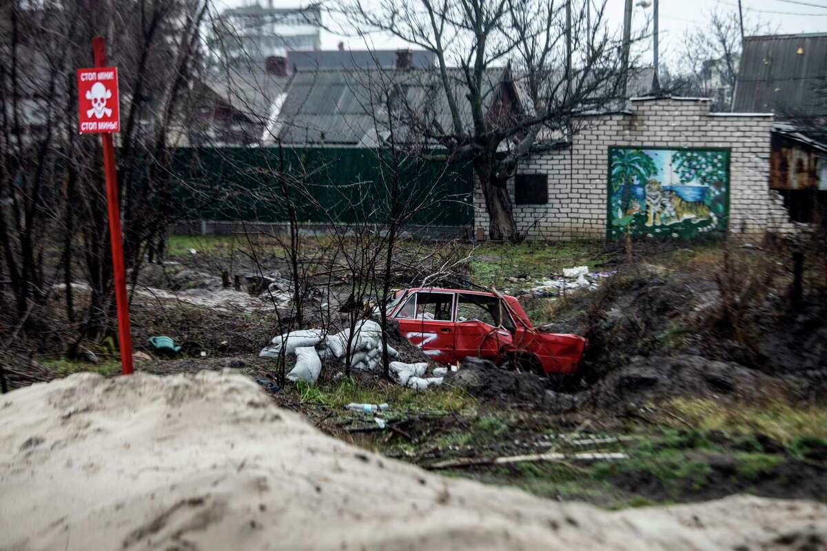 A sign warns of unexploded mines in Lyman, a city in Ukraine's Donetsk region, on Dec. 17, 2022.