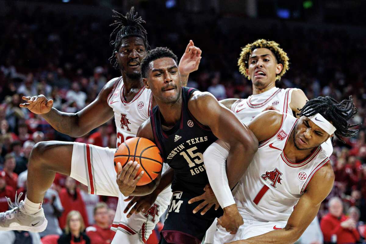 FAYETTEVILLE, ARKANSAS - JANUARY 31: Henry Coleman III #15 of the Texas A&M Aggies fights for a rebound in the first half against Ricky Council IV #1 of the Arkansas Razorbacks at Bud Walton Arena on January 31, 2023 in Fayetteville, Arkansas.