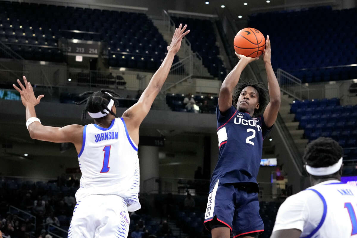 Connecticut's Tristen Newton (2) shoots over DePaul's Javan Johnson during the first half of an NCAA college basketball game Tuesday, Jan. 31, 2023, in Chicago. (AP Photo/Charles Rex Arbogast)
