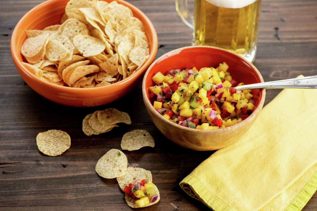 This image shows a recipe for tropical fruit salsa. AP food writer Katie Workman says it's extremely simple to make your own salsa for Super Bowl celebrations. All you need is a willingness to chop, mince and dice. (Cheyenne Cohen via AP)