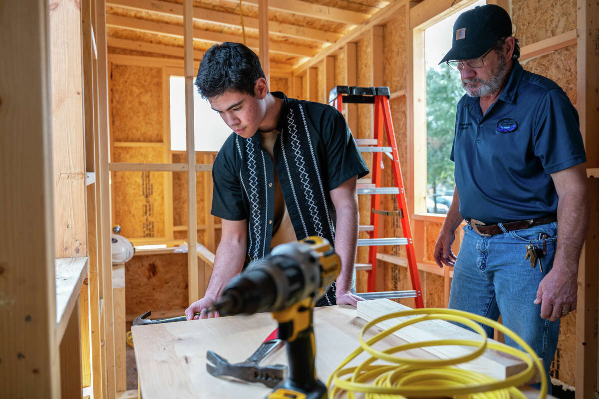 Carl Wunsche Sr. High School instructor helps student build a tiny house.
