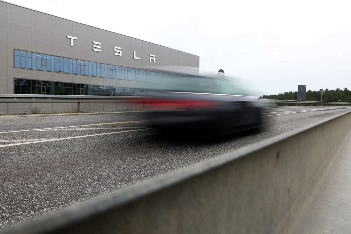 An automobile travels past the Tesla Inc. Gigafactory in Gruenheide, Germany, on Saturday.