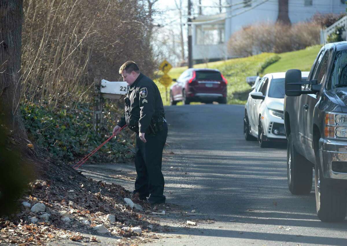 Police searched an area across the street from a house on Reservoir Street where two people have died in a suspected murder-suicide. Wednesday morning, February 1, 2023, in Bethel, Conn.