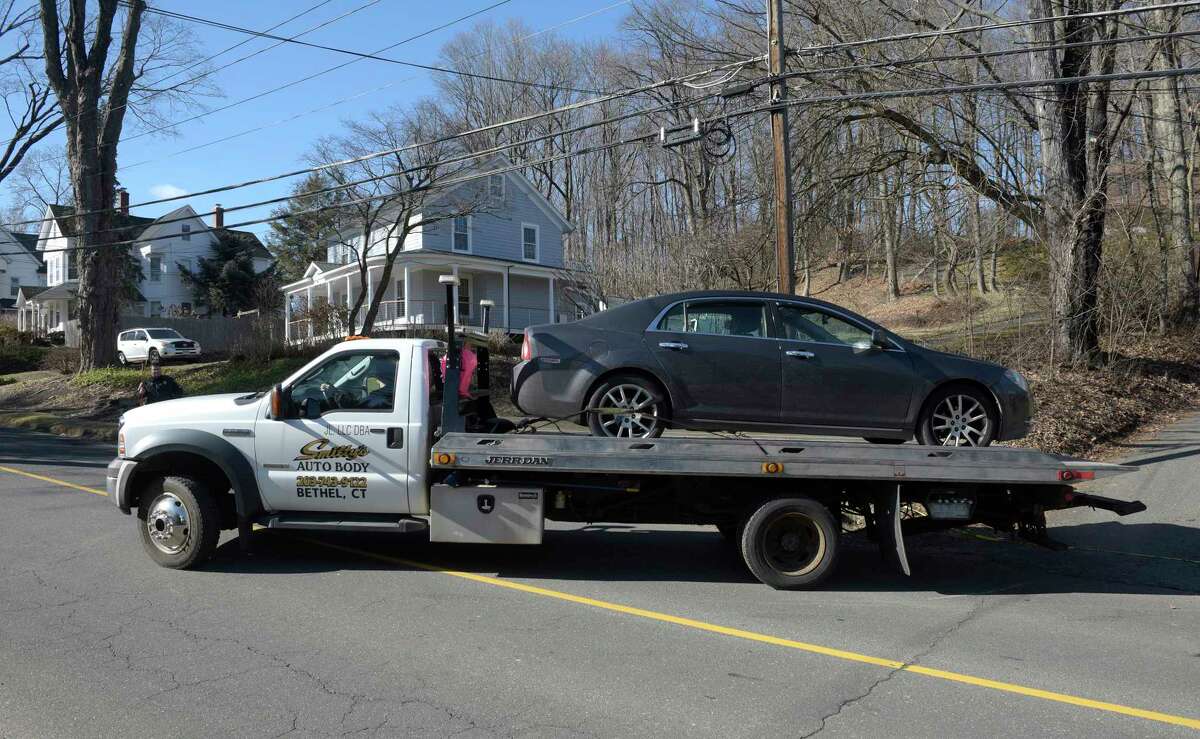 Police removed a car from the driveway of a house on Reservoir Street where two people have died in a suspected murder-suicide. Wednesday morning, February 1, 2023, in Bethel, Conn.