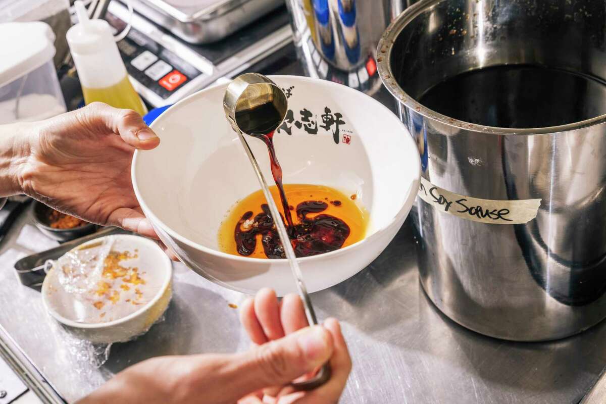 Kajiken franchise owner Tim Lu mixes sauces for a bowl of abura soba at the San Mateo restaurant.
