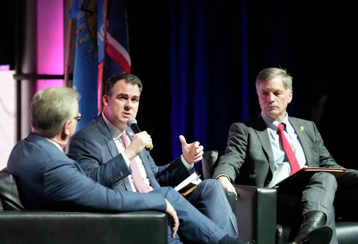 Carl Campbell, co-founder and COO Alamo Resources, left, moderates a panel discussion with Oklahoma Governor J. Kevin Stitt, center, and Wyoming Governor Mark Gordon, right, during the NAPE Summit, an annual oil and gas conference at the George R. Brown Convention Center Wednesday, Feb. 1, 2023, in Houston.