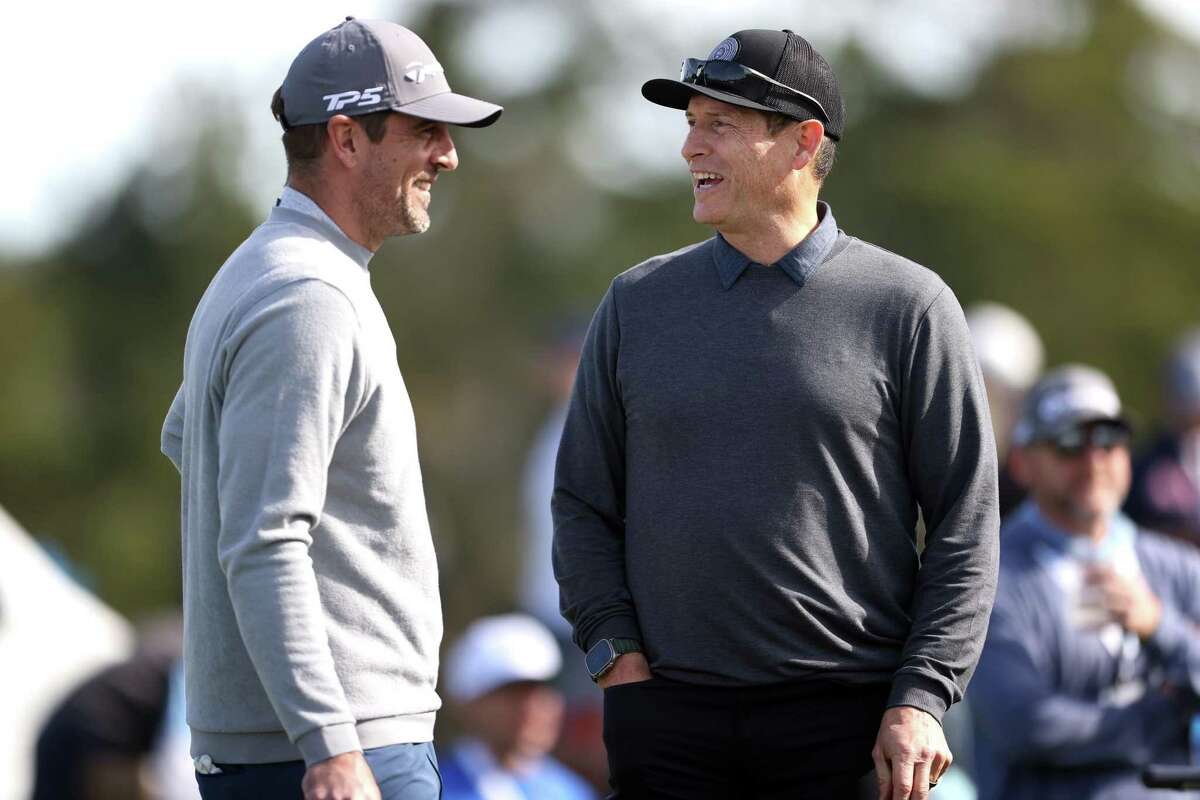 Former San Francisco 49ers’ quarterback Steve Young chats with Green Bay Packers’ QB Aaron Rodgers during The Chevron Challenge putting competition during AT&T Pebble Beach Pro-Am at Pebble Beach Golf Links in Pebble Beach Calif., on Wednesday, February 1, 2023.