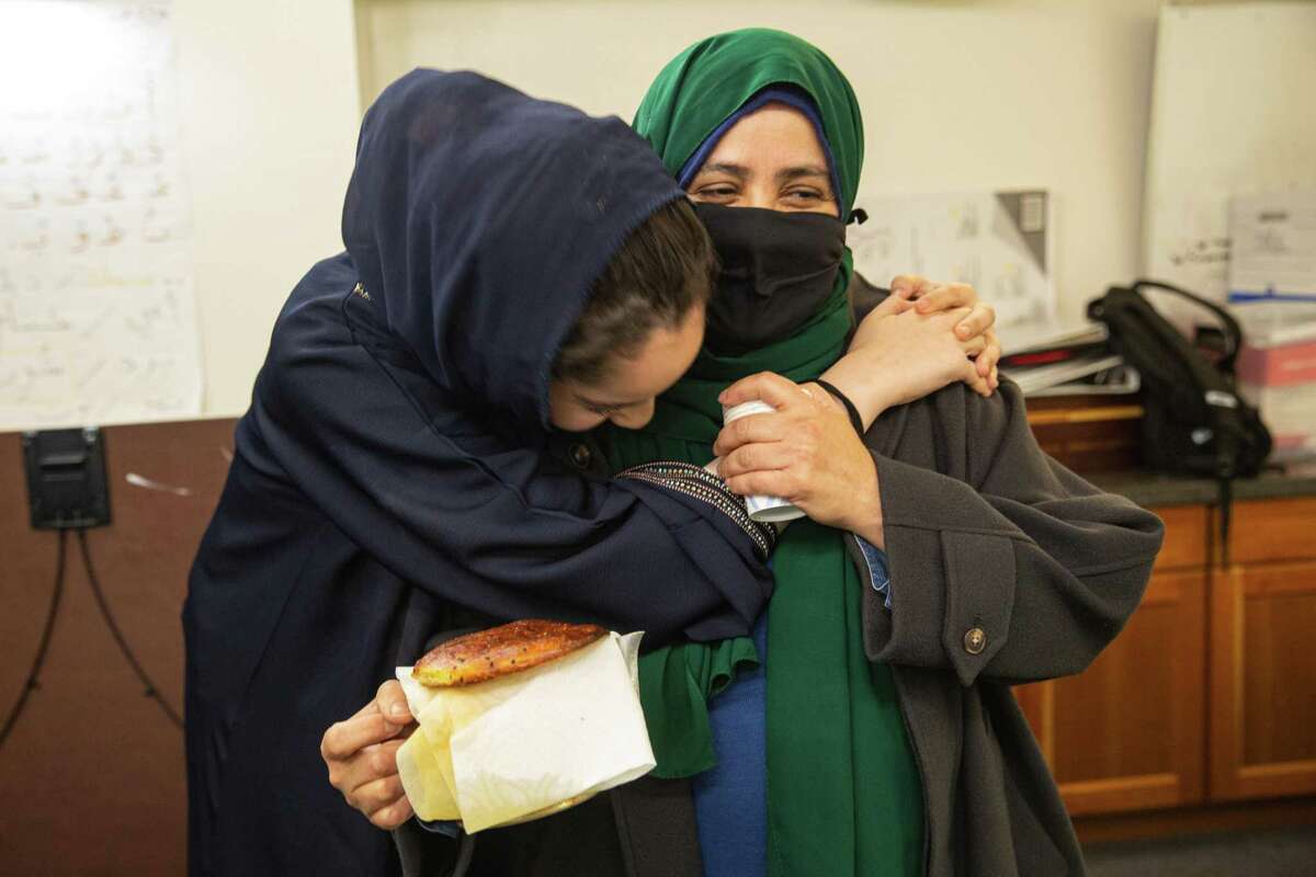 FILE —Bushra Alabsi, teacher, is greeted by one of her students, Aisha Majdoub, 15, in the Tenderloin Family Housing building where Alabsi’s family has lived for 25 years. On Friday, December 9, 2022. San Francisco, Calif.