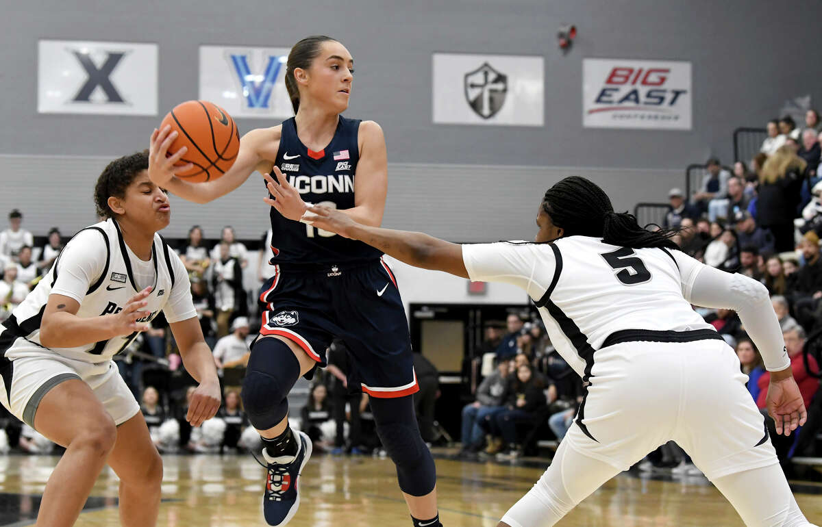 UConn's Nika MÃ¼hl, center, hauls in a rebound during the first half of an NCAA college basketball game against Providence, Wednesday, Feb. 1, 2023, in Providence, R.I. (AP Photo/Mark Stockwell)