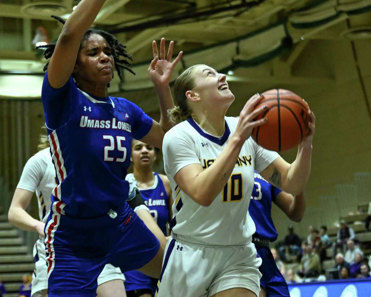 UAlbany graduate student Ellen Hahne drives to the basket in front of UMass Lowell sophomore Amaya Dowdy on Wednesday, Feb. 1, 2023, at Hudson Valley Community College in Troy, NY.
