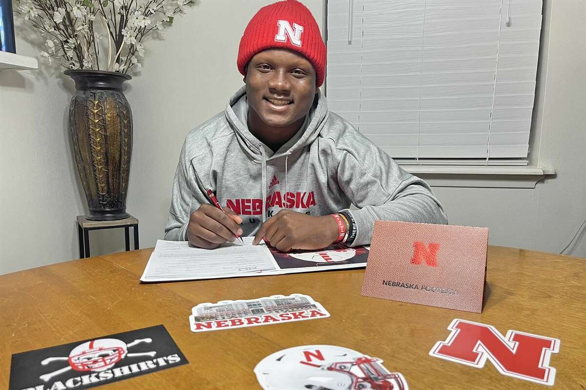 Cypress Woods senior Dylan Rogers smiles after signing his letter of intent to play college football at the University of Nebraska during the early signing period.