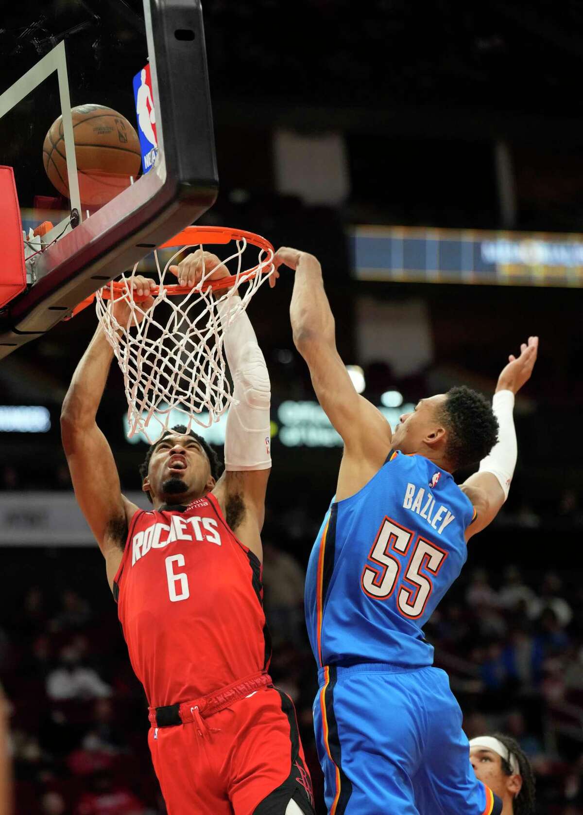 Houston Rockets forward Kenyon Martin Jr. (6) is fouled going to the basket by Oklahoma City Thunder forward Darius Bazley (55) during the first half of a NBA basketball game at Toyota Center on Wednesday, Feb. 1, 2023 in Houston.