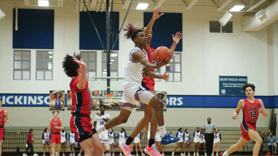 Dickinson's Qasim Boyd (2) tries to lay up a shot past Clear Lake's Armani Reese (22) Wednesday, Feb 1, 2023 at Dickinson high School.