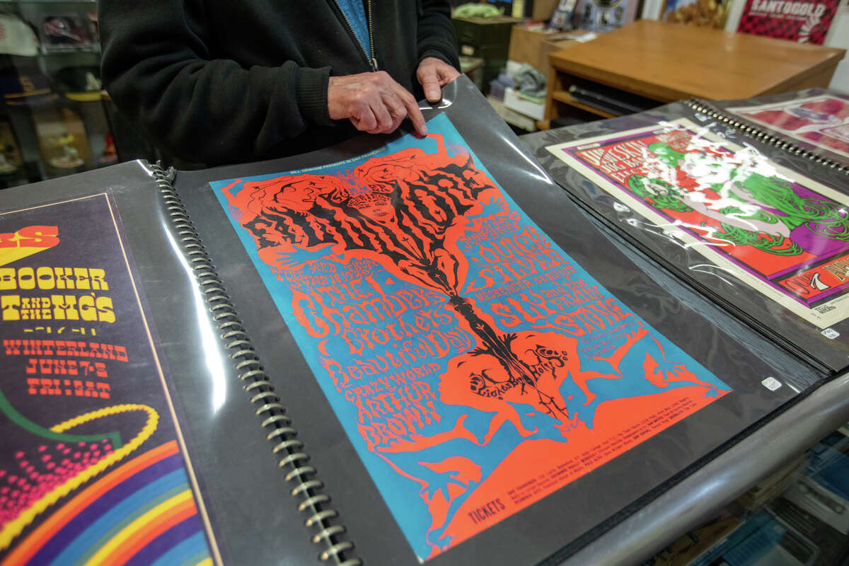 Dennis King shows some of the concert posters he has for sale at the D.King Gallery in Berkeley, Calif., on Jan. 23, 2023.