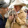 Famed armadillo artist Jim Franklin, left, and Texas singer-songwriter Gary P. Nunn get an up-close look at an armadillo named Bee Cave Bob in 2010. Bob serves as Texas's answer to Punxsutawney Phil.