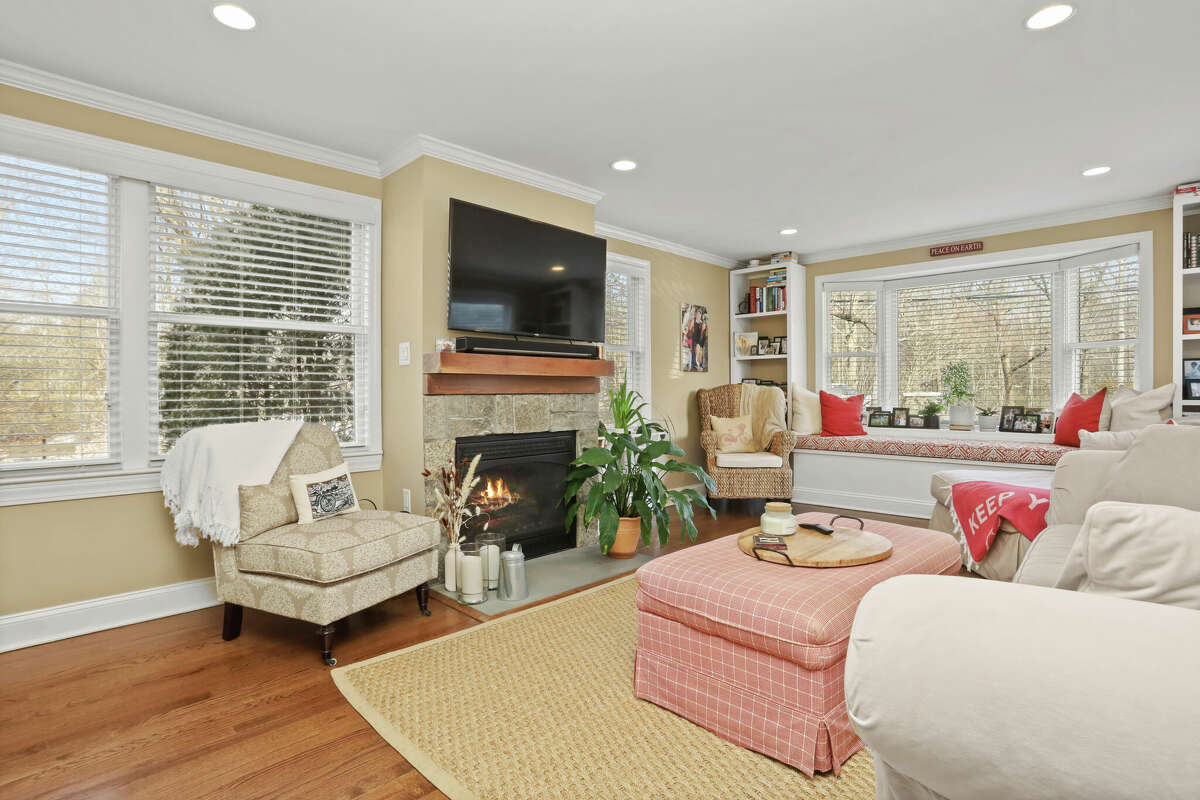 The home’s living room has a new gas fireplace and a charming built-in window seat. 