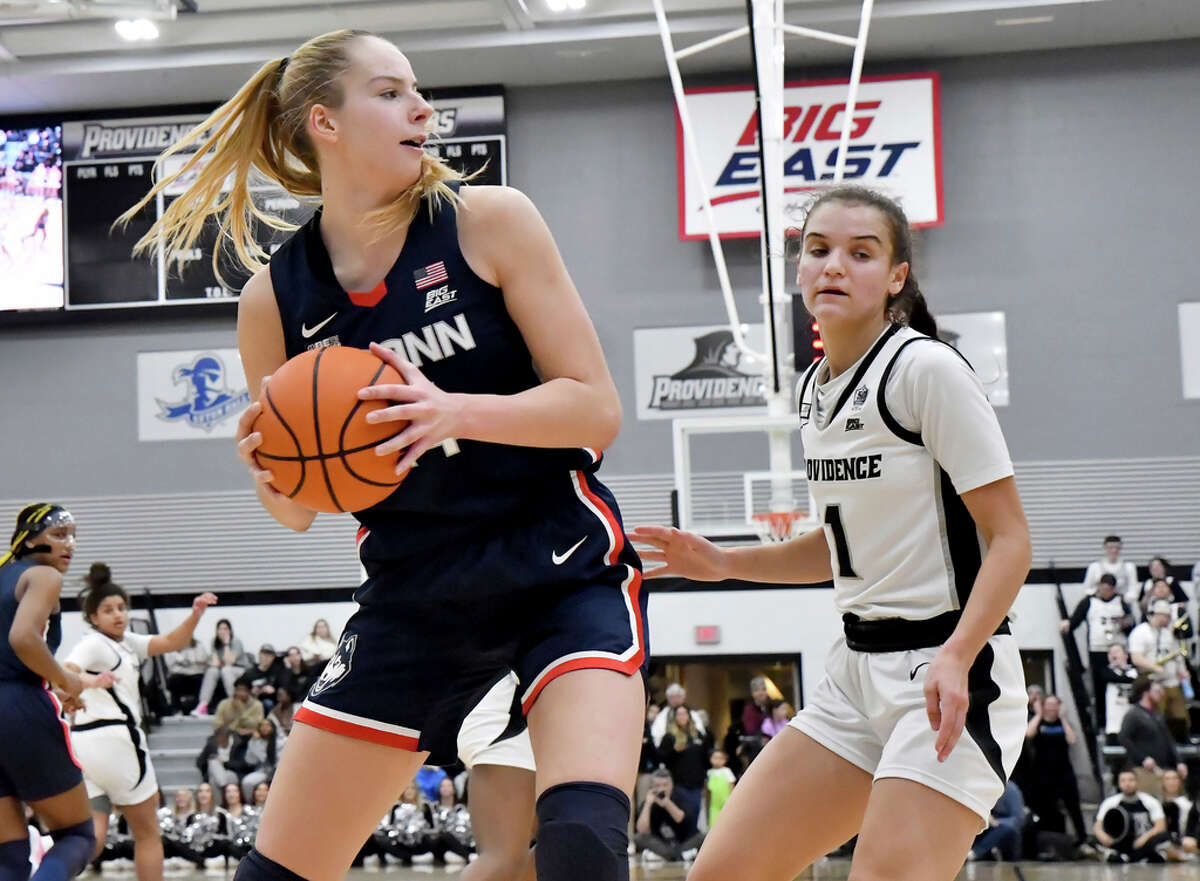 UConn's Dorka JuhÃ¡sz, left, grabs a rebound as Providence's Kylee Sheppard (1) watches during the second half of an NCAA college basketball game, Wednesday, Feb. 1, 2023, in Providence, R.I. (AP Photo/Mark Stockwell)
